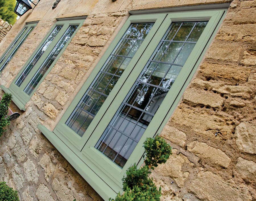 green window against brick house