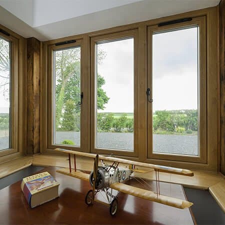 Office with sash windows looking out on lush green garden