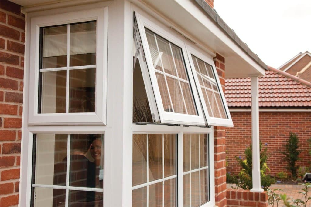 Close-up view of white-framed double-glazed windows in red face brick house